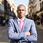 Handsome black man wearing suit in urban background